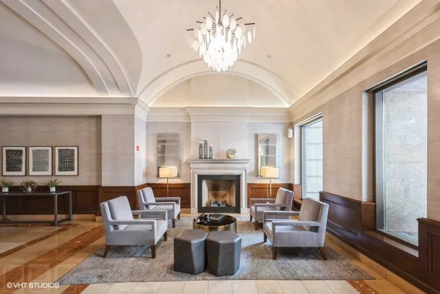 a living room with furniture a fireplace and a large window