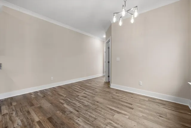 a view of a room with wooden floor and windows