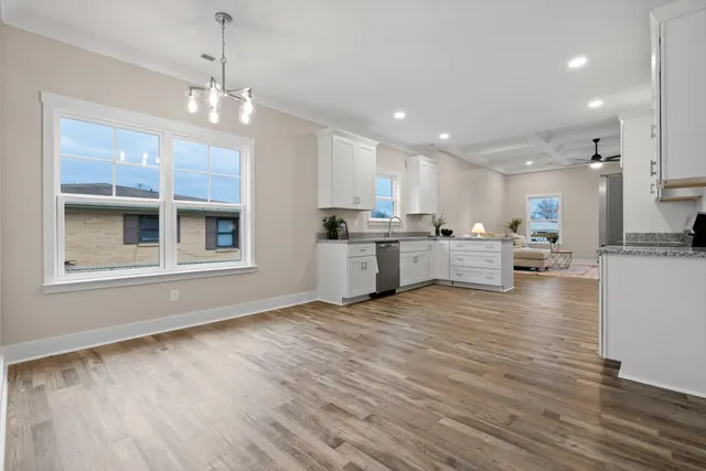 a bathroom with a toilet a sink a mirror a bathtub and vanity