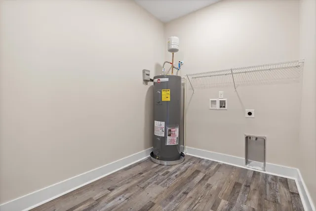 a view of a hallway with wooden floor and closet area