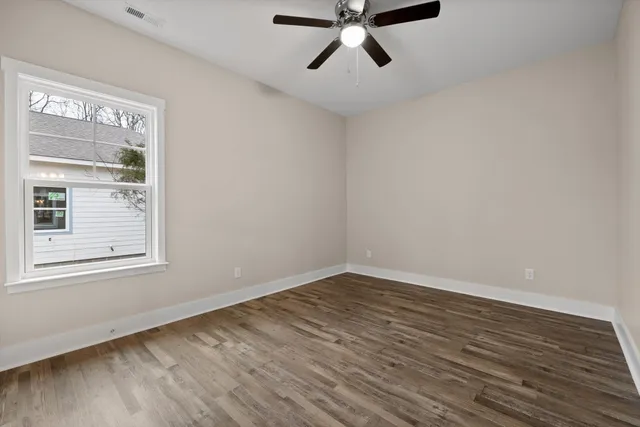 a bathroom with a granite countertop sink a toilet and a mirror