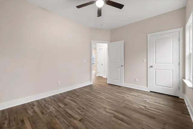 a bathroom with a granite countertop sink a toilet and shower