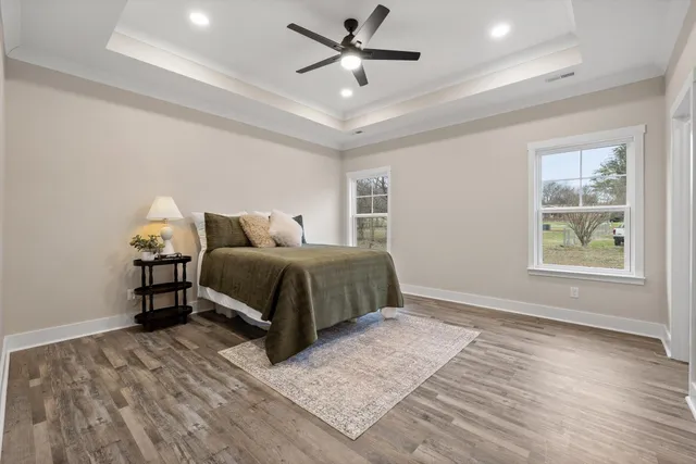 a front view of a house with large tree