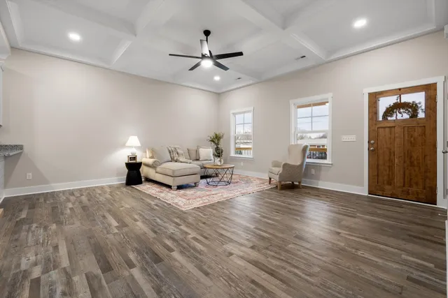 a living room with furniture and wooden floor