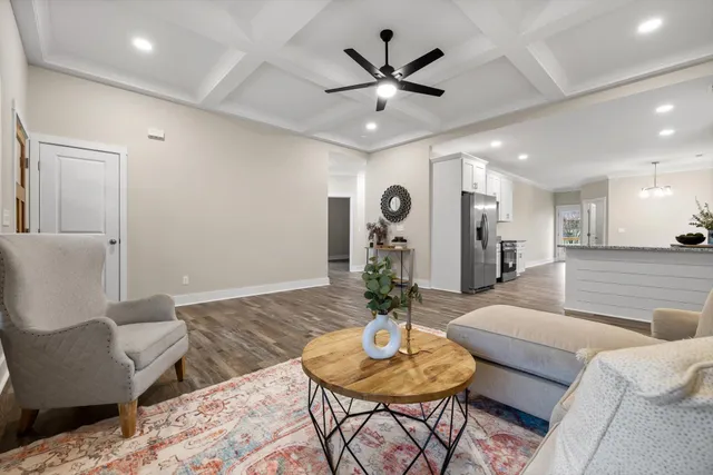 a living room with furniture and a wooden floor