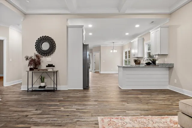 a kitchen with stainless steel appliances kitchen island granite countertop a refrigerator and a sink