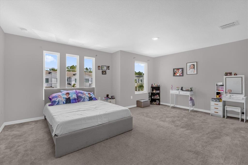 3470 Beau Road Kissimmee, FL 34746 - Photo 16 of 40 a bedroom with a bed and furniture