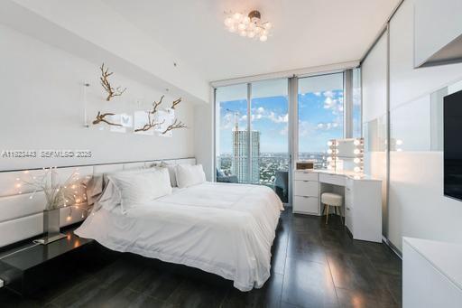 92 Southwest 3rd Street, Unit 5108 Miami, FL 33130 - Photo 11 of 23 a bedroom with a large bed and a window