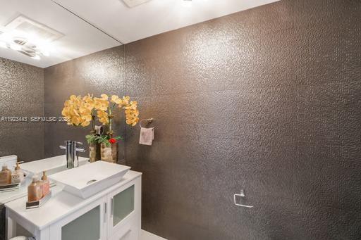 92 Southwest 3rd Street, Unit 5108 Miami, FL 33130 - Photo 17 of 23 a bathroom with a sink vanity and a mirror