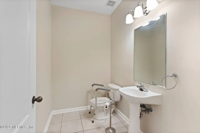 a bathroom with a sink a mirror and a toilet