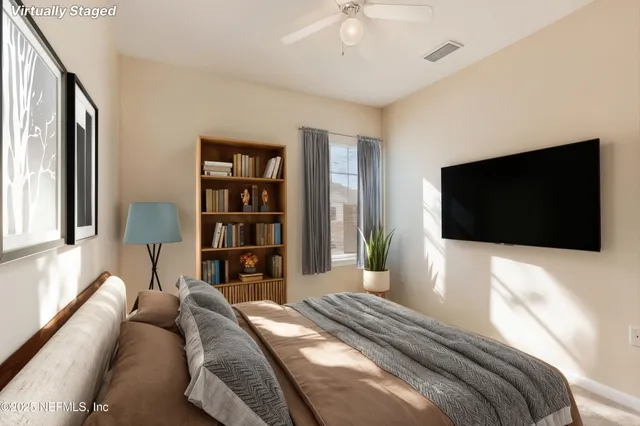 a bedroom with a large bed and a flat screen tv