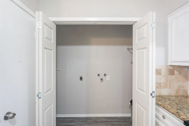 an empty room with a window and a ceiling fan