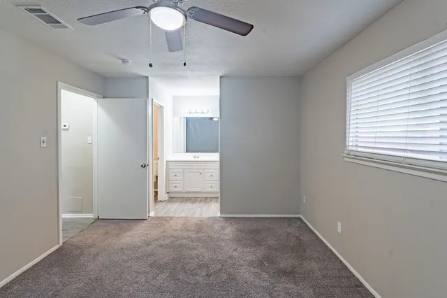 a white toilet sitting next to a bathroom sink