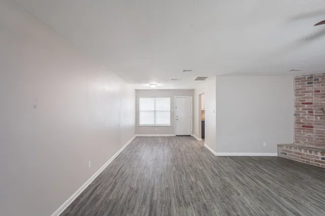 a kitchen with granite countertop a sink stove and refrigerator