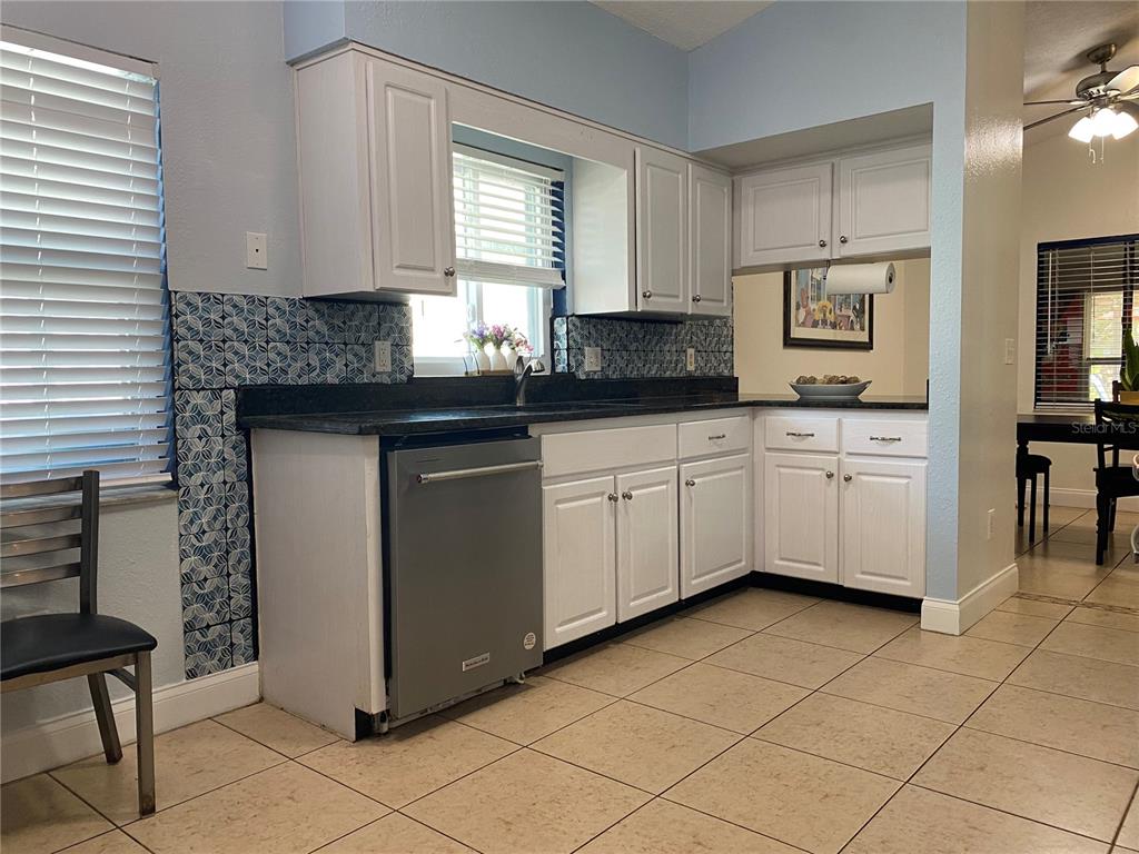 1020 Vernon Loop Oviedo, FL 32765 - Photo 13 of 34 a kitchen with stainless steel appliances granite countertop a sink and cabinets