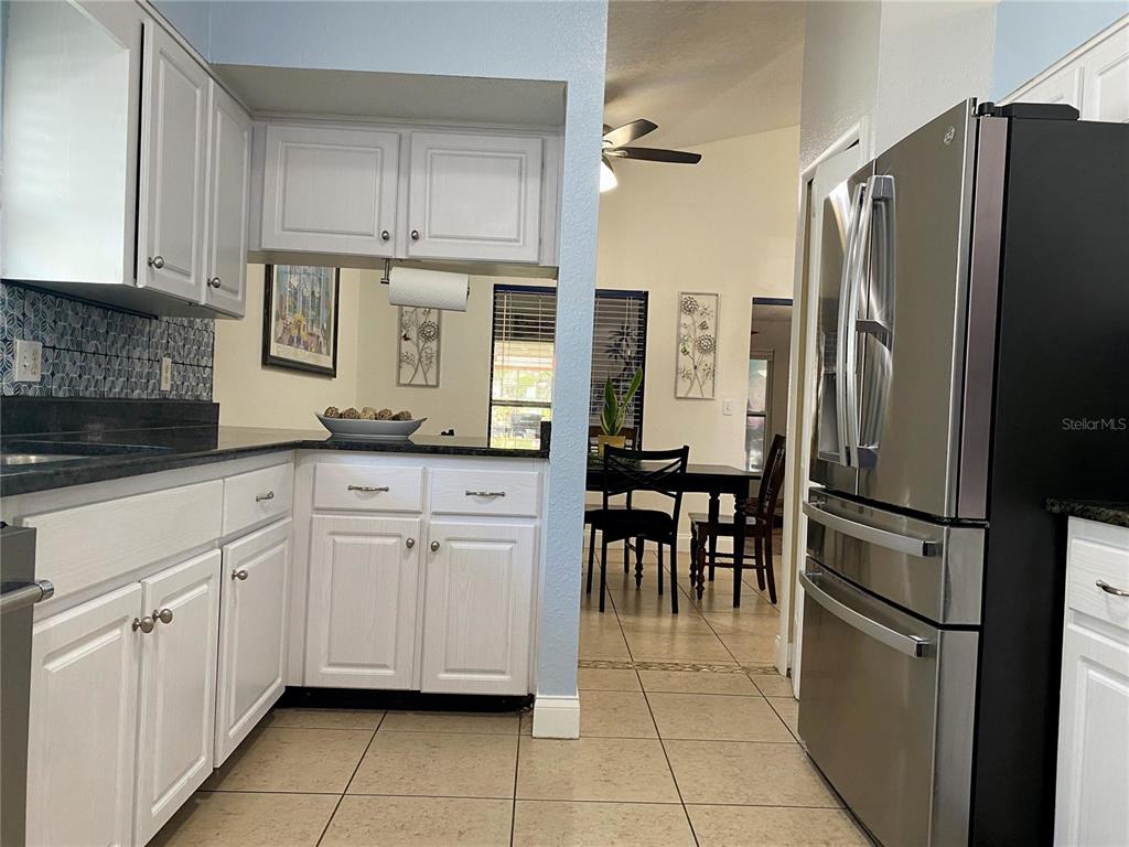 1020 Vernon Loop Oviedo, FL 32765 - Photo 15 of 34 a kitchen with white cabinets stainless steel appliances and a sink