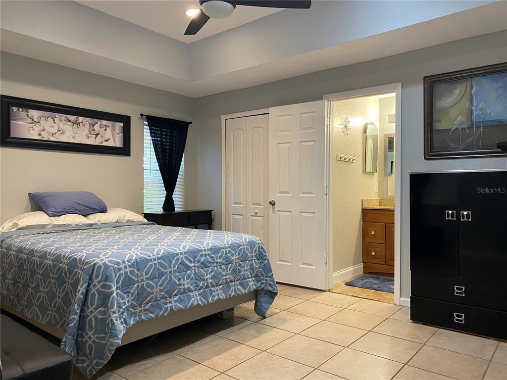 1020 Vernon Loop Oviedo, FL 32765 - Photo 17 of 34 a bedroom with a bed and a lamp on dresser