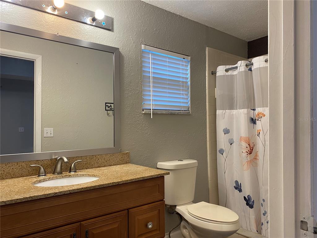1020 Vernon Loop Oviedo, FL 32765 - Photo 19 of 34 a bathroom with a granite countertop sink toilet and shower