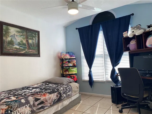 a bedroom with a bed cabinets and a window