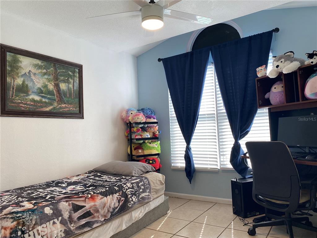 1020 Vernon Loop Oviedo, FL 32765 - Photo 25 of 34 a bedroom with a bed cabinets and a window