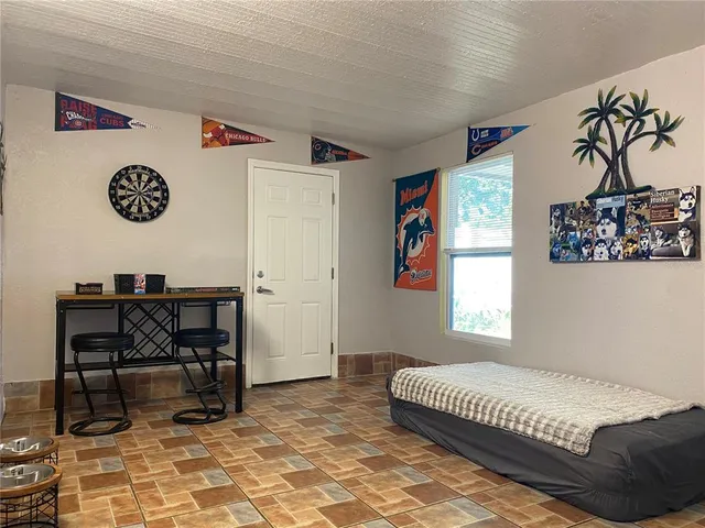 a bedroom with a bed and a table in it