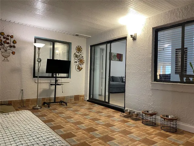 a view of a livingroom with wooden floor and a flat screen tv