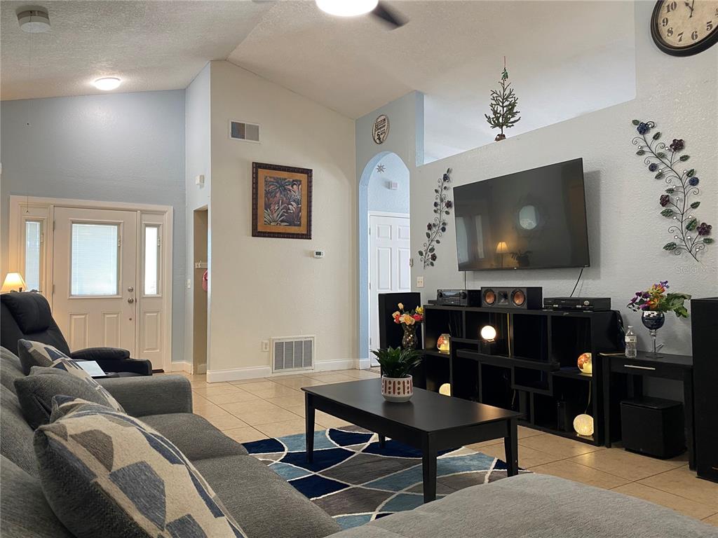 1020 Vernon Loop Oviedo, FL 32765 - Photo 4 of 34 a living room with furniture and a flat screen tv