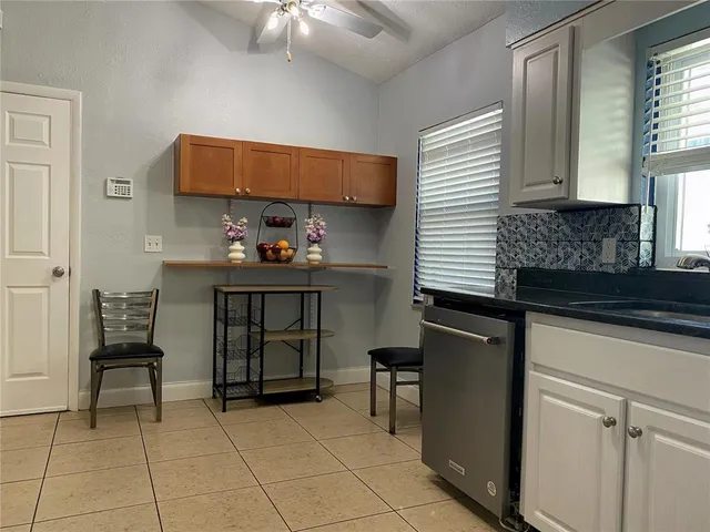 a kitchen with a cabinets and chairs