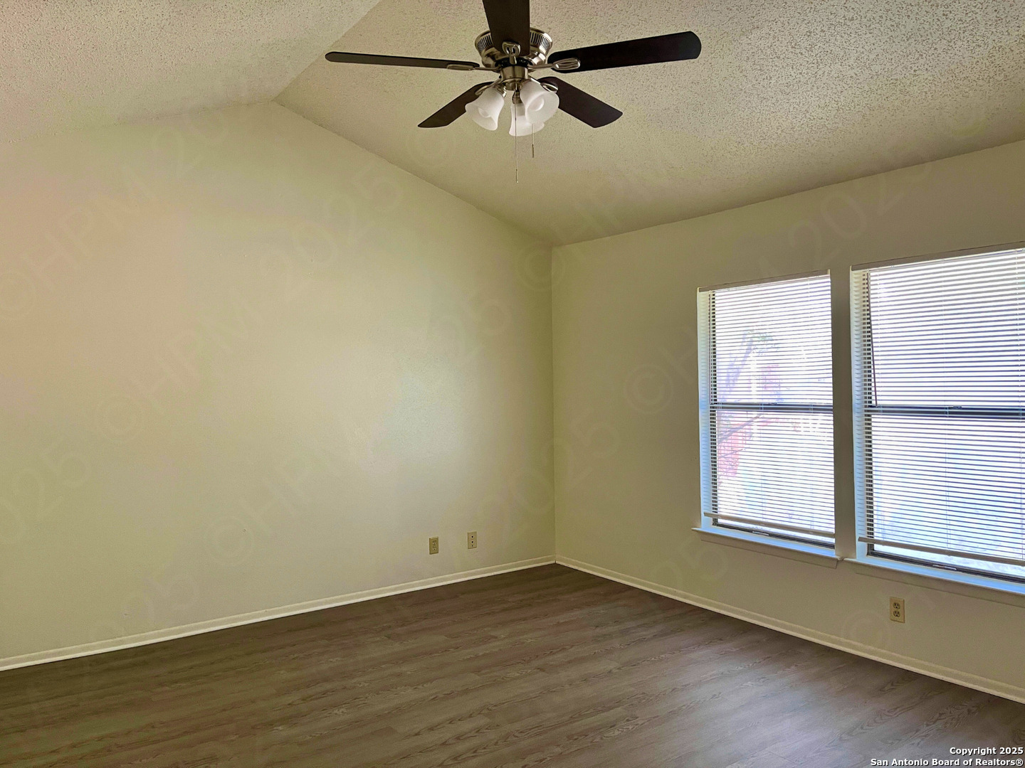 7315 Ridge Beach Drive Converse, TX 78109 - Photo 13 of 17 an empty room with wooden floor fan and windows