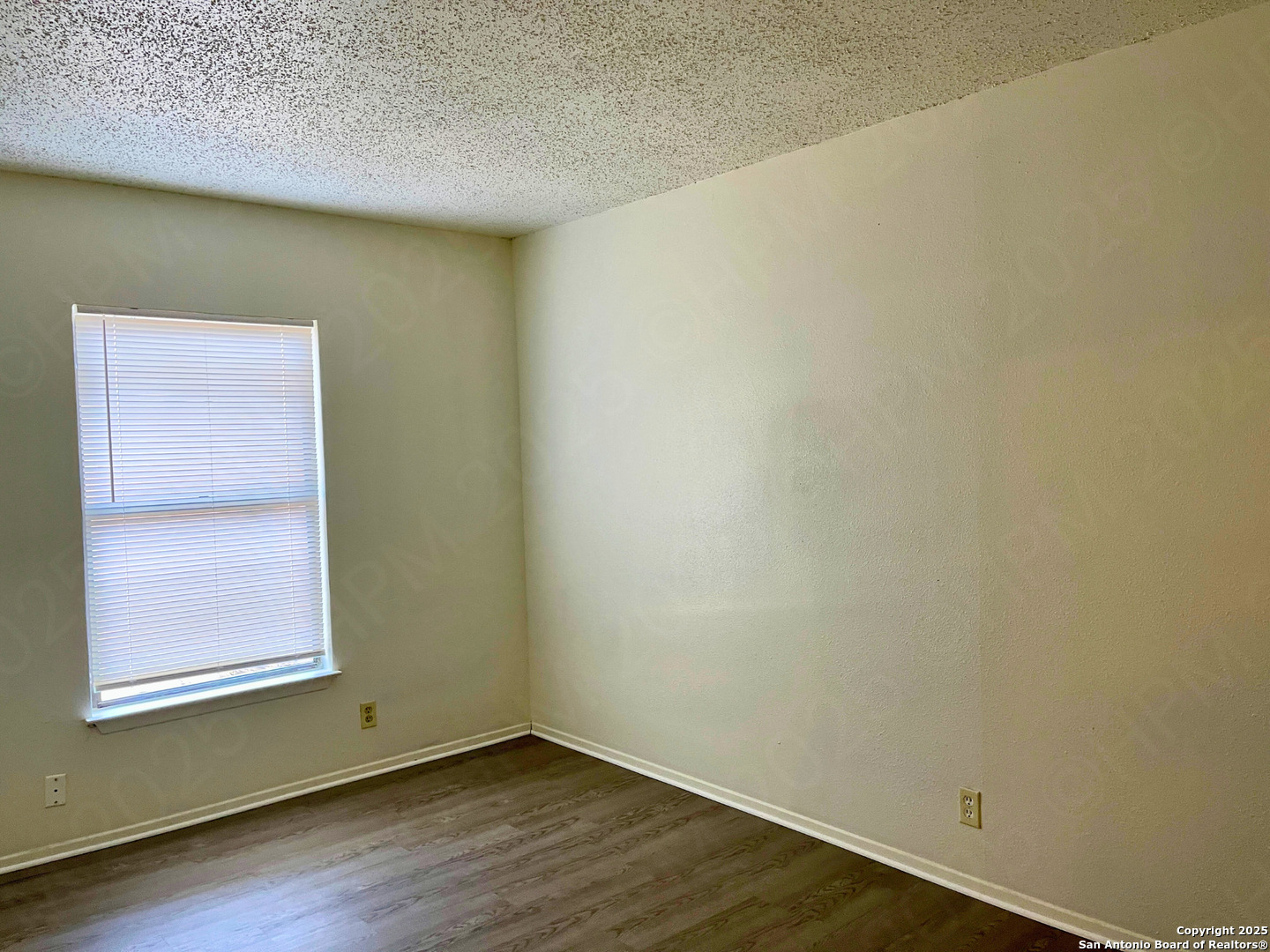 7315 Ridge Beach Drive Converse, TX 78109 - Photo 8 of 17 a view of an empty room with wooden floor and a window