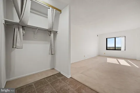 a view of a balcony from an empty room