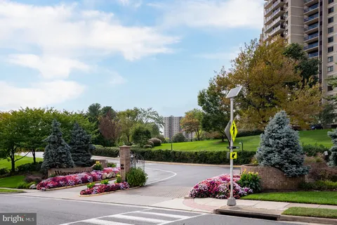a view of a tennis court with tall buildings