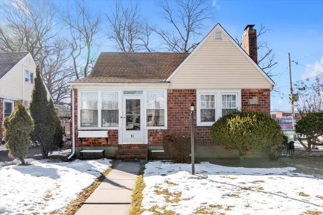 a view of a white house with a yard in front of it