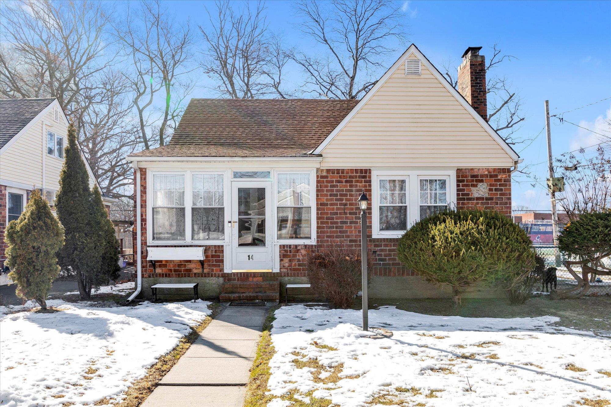 a view of a white house with a yard in front of it