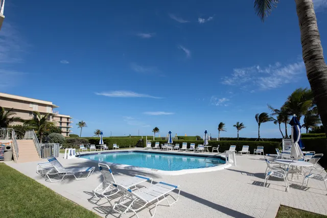 a view of a swimming pool with outdoor seating