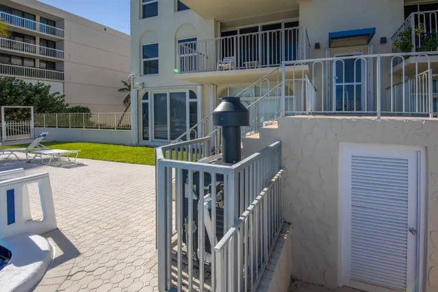 a view of a house with swimming pool and sitting area