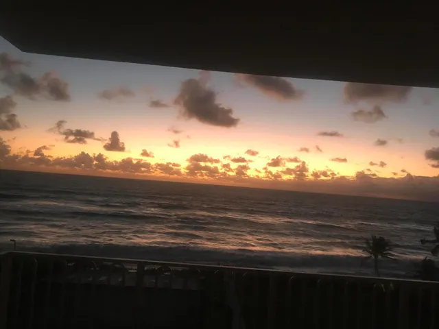 a dining room with furniture a chandelier and window
