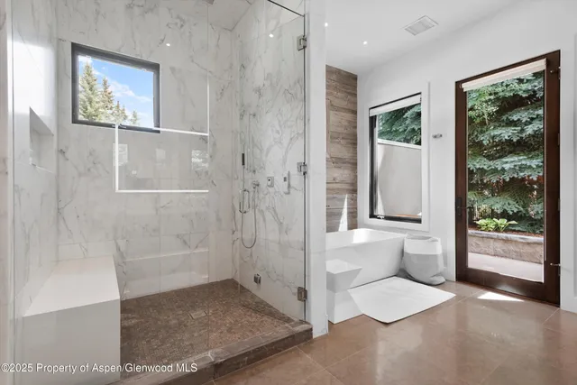 a view of a bathroom with a glass door shower and a sink