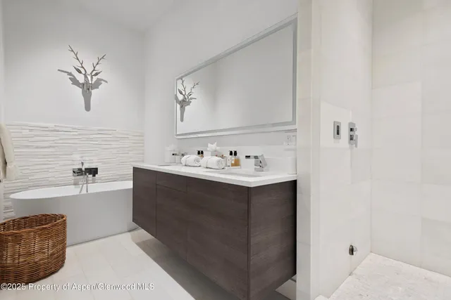 a bathroom with a tub sink and mirror
