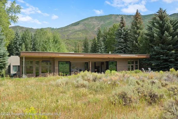 a house with trees in the background
