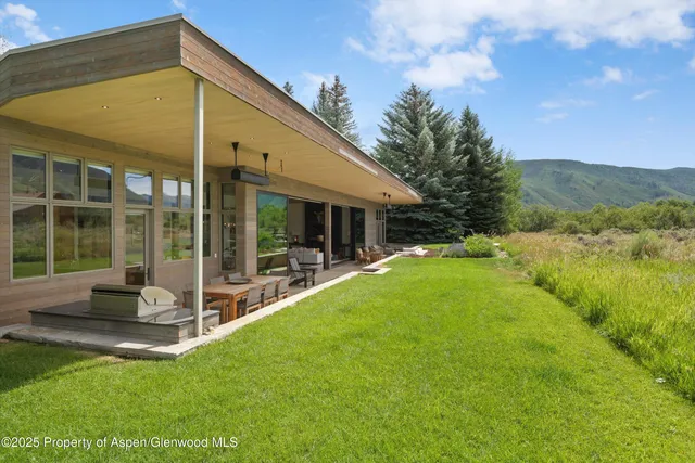 a view of house with backyard porch and outdoor seating