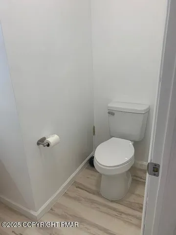 a white toilet sitting next to a shower