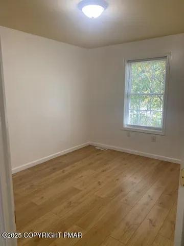 an empty room with wooden floor