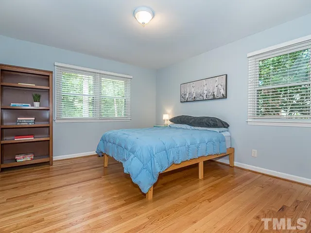 a bedroom with a bed and a bookshelf