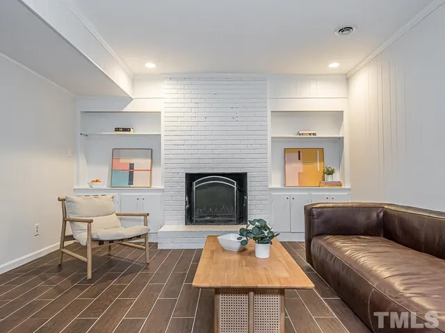 a view of a dining room with furniture and a fireplace
