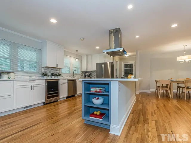 a kitchen with stainless steel appliances granite countertop a stove and a refrigerator