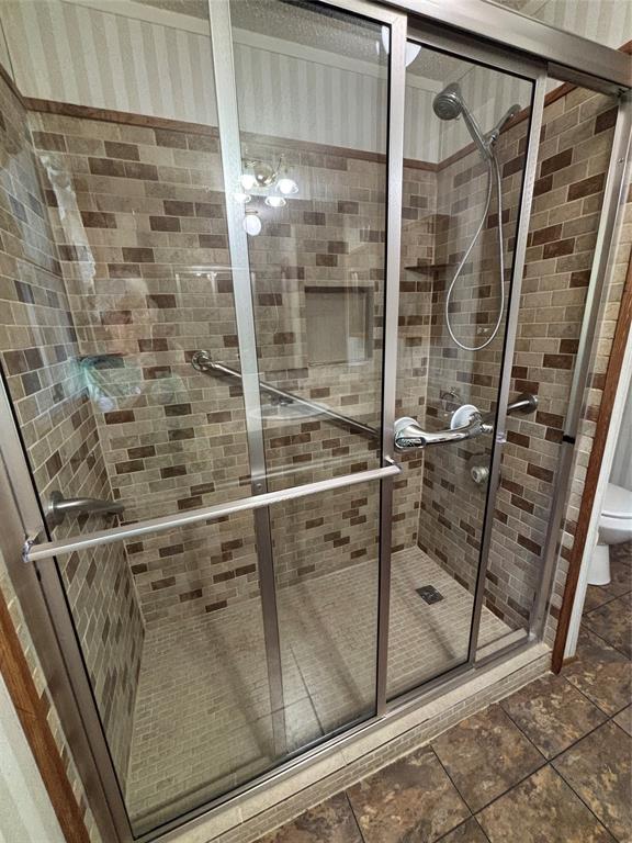 206 Holiday Rambler Drive Whitney, TX 76692 - Photo 17 of 28 Glass-enclosed shower with a handheld shower fixture