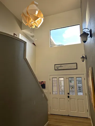 a kitchen with stainless steel appliances a sink a stove a refrigerator a center island and cabinets