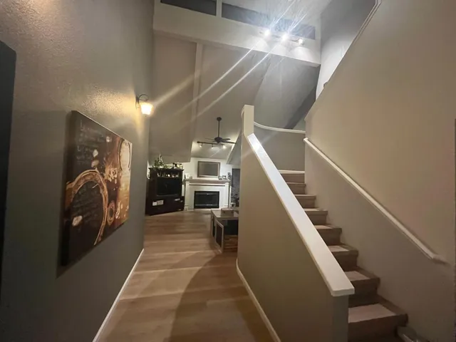 a kitchen with stainless steel appliances kitchen island granite countertop a sink refrigerator and cabinets