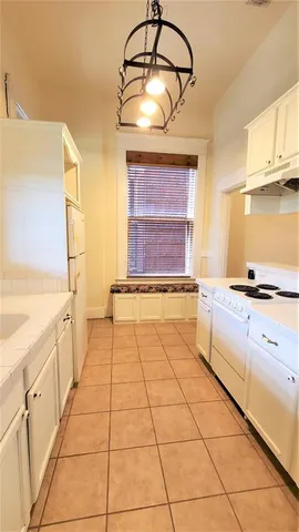 a kitchen with a stove and a cabinets